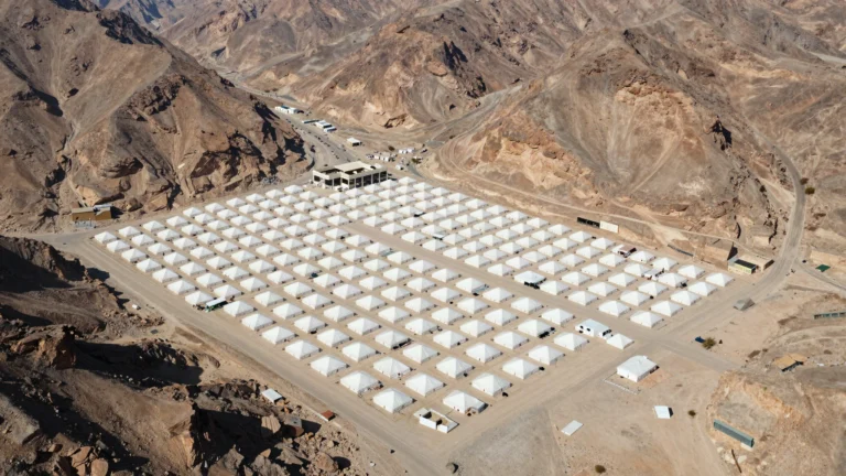 AI illustration of the white tent city of Mina in a mountain valley near Makkah